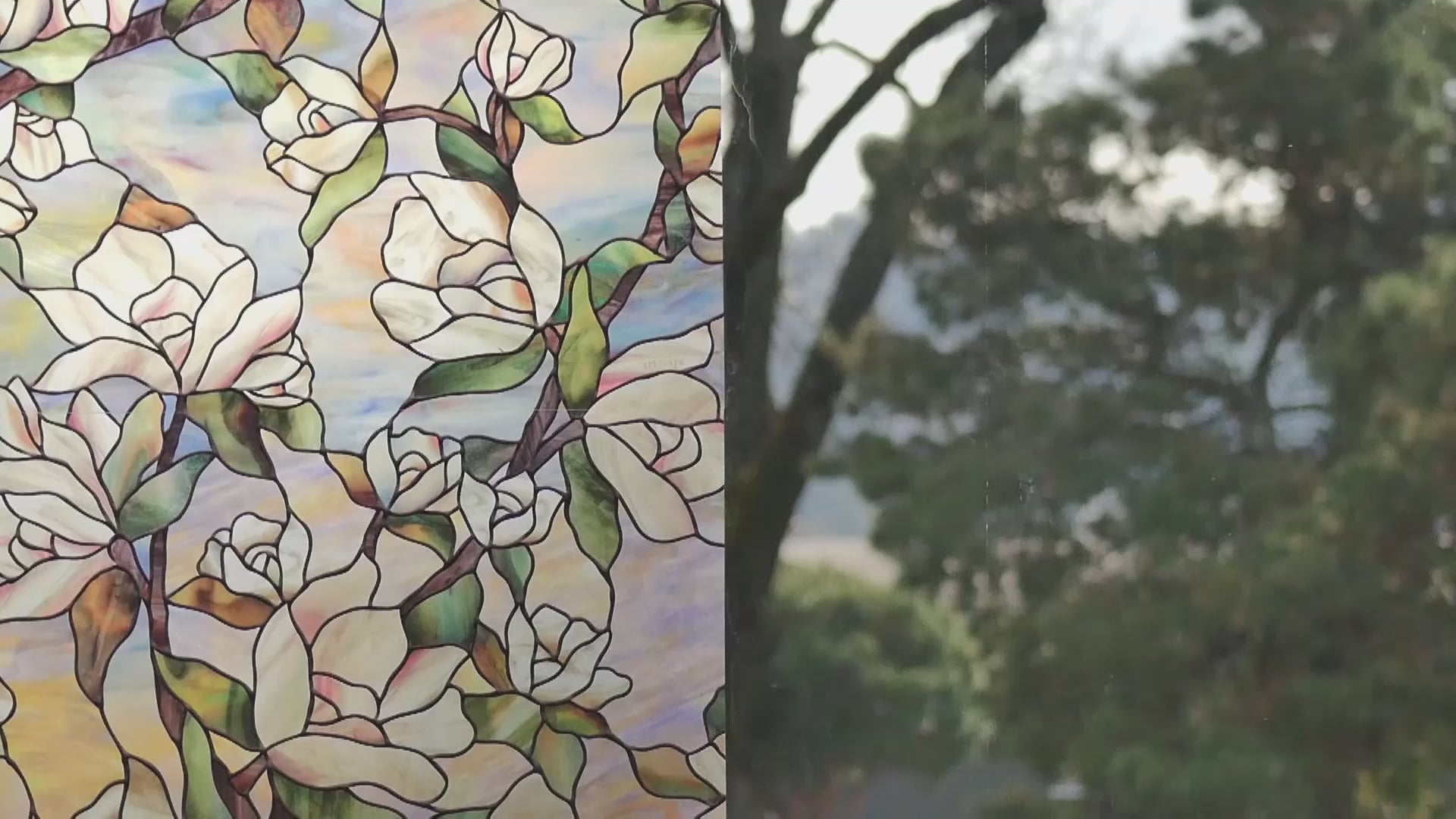 Load video: Window half covered on left side with mosaic-like window film.